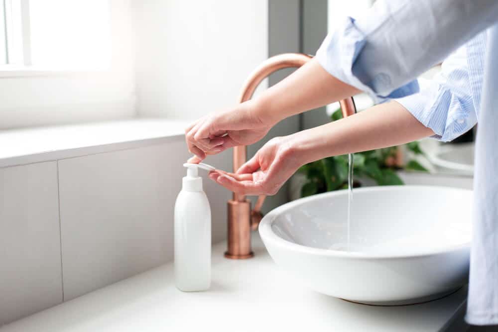 Mujer lavándose las manos con jabón antibacteriano