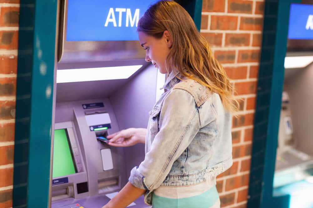 Mujer sacando dinero de un cajero automático